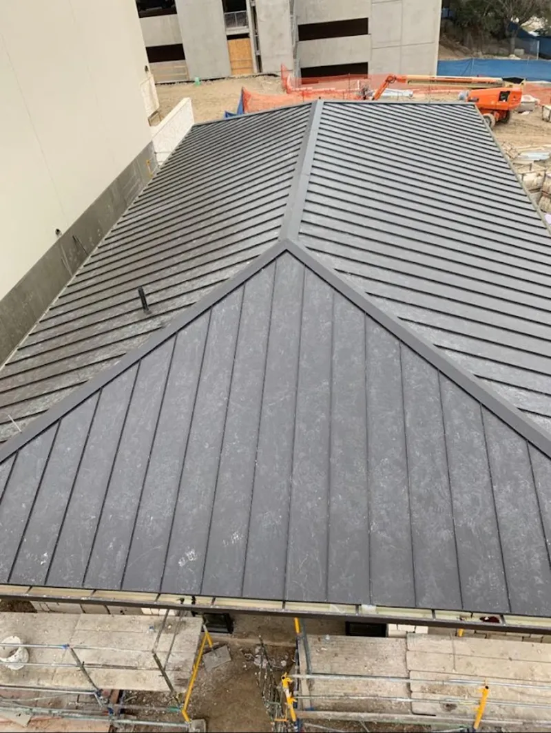 Commercial metal roof construction with crane equipment in Red Bank